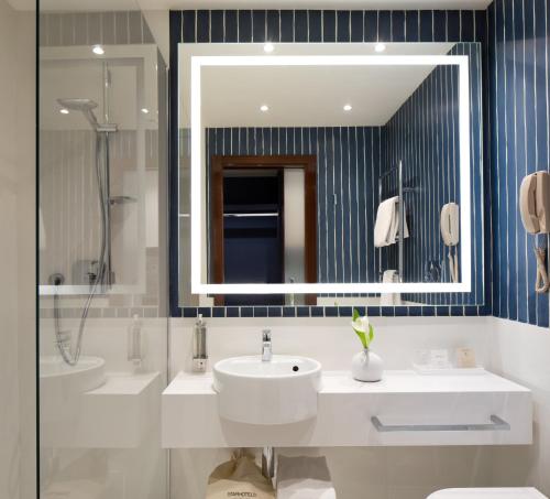a bathroom with a sink and a mirror at Starhotels President in Genova