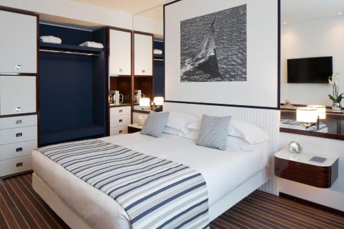 a bedroom with a large bed and a desk at Starhotels President in Genova