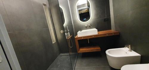 a bathroom with a toilet and a sink and a mirror at Gioiamia - Luxury Rooms in Cattedrale in Palermo