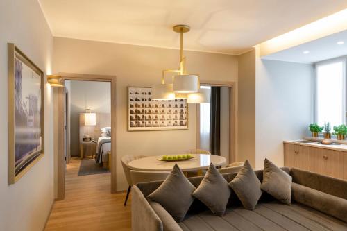 a living room with a couch and a table at Rosa Grand Milano - Starhotels Collezione in Milan