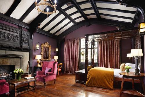 a bedroom with a canopy bed and a fireplace at The Gore London - Starhotels Collezione in London