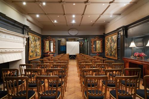 a room with rows of chairs and a whiteboard at The Gore London - Starhotels Collezione in London