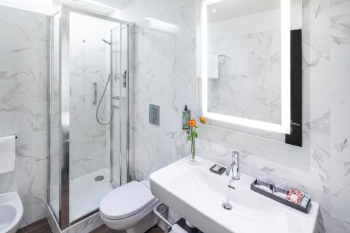 a bathroom with a sink and a toilet and a shower at Starhotels Majestic in Turin