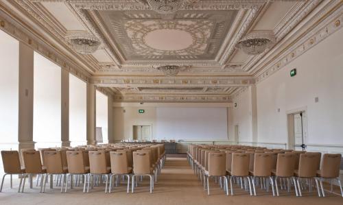 an empty room with chairs and a white screen at Savoia Excelsior Palace Trieste - Starhotels Collezione in Trieste