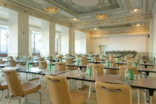a large room with tables and chairs in it at Savoia Excelsior Palace Trieste - Starhotels Collezione in Trieste