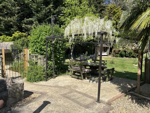 a garden with a pergola and a picnic table at Woodpaddock Bed & Breakfast in March