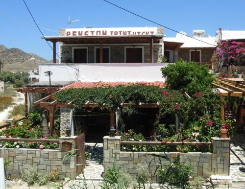 un vecchio edificio con dei fiori di fronte di Pension Irini-Vicky a Ios Chora