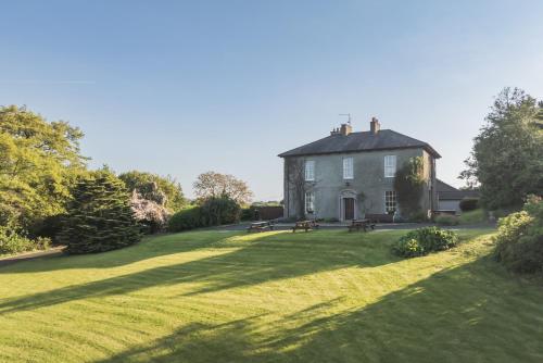 a large house with a large grass yard at Willowbank House & Farm in Keady