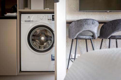 a washer and dryer in a kitchen next to a washing machine at Luxury Honey Moon Apartments with Free Underground Parking in Kaunas