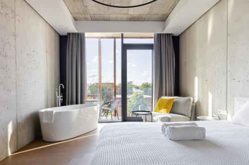 a bedroom with a bath tub and a bed at Luxury Honey Moon Apartments with Free Underground Parking in Kaunas