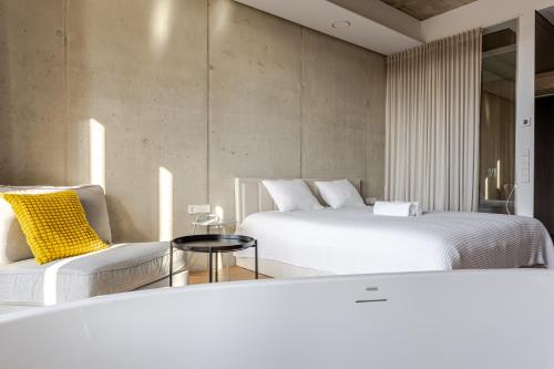 a hotel room with two beds and a couch at Luxury Honey Moon Apartments with Free Underground Parking in Kaunas