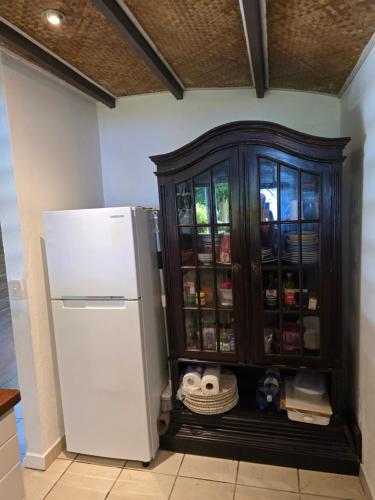 a refrigerator and a cabinet in a kitchen at Angels Beachhouse - Beachfront, fast internet, Queen beds, new owners in Port Vila