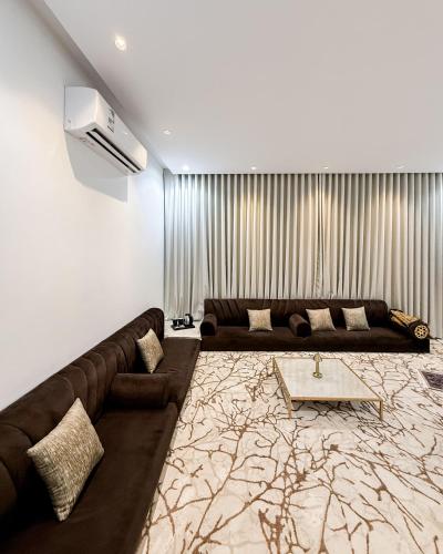 a living room with a couch and a table at المدينه المنوره in Al Madinah