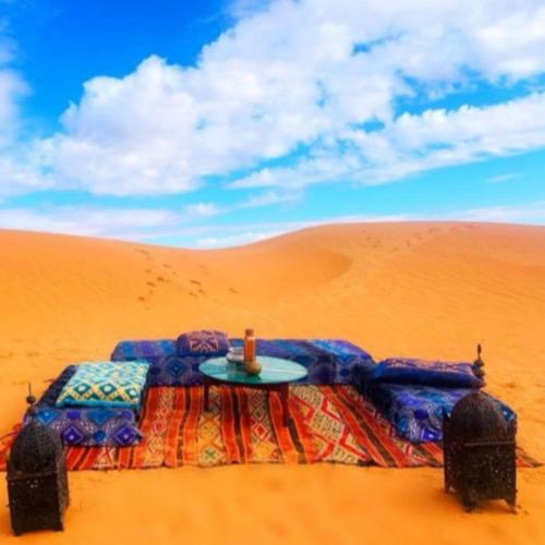 a table in the sand in the desert at Merzouga tente luxury in Merzouga