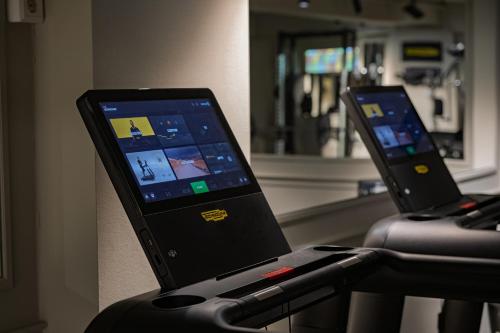 two monitors on a treadmill in a hospital room at Grand Hotel Terminus in Bergen