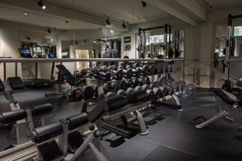 a gym with a row of weight machines at Grand Hotel Terminus in Bergen