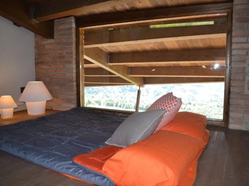 a bed in a room with a large window at Belvilla by OYO Cobert de l'Era in Oden