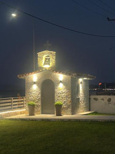 a small stone building with lights on it at night at Costa Kalamos Suites in Kalamos