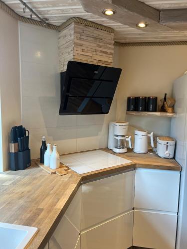 a kitchen with a counter top with a microwave at Cheerful house with sauna and bathtub in Almunge