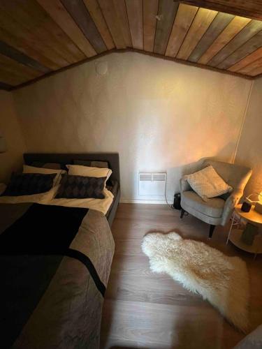 a bedroom with two beds and a chair and a ceiling at Cheerful house with sauna and bathtub in Almunge