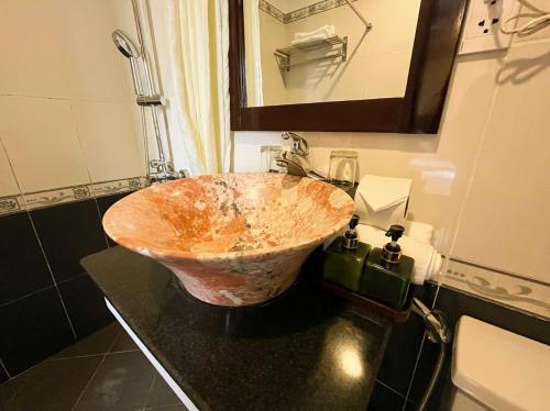 a bathroom with a wooden sink on a counter at Golden River Hotel in Hoi An