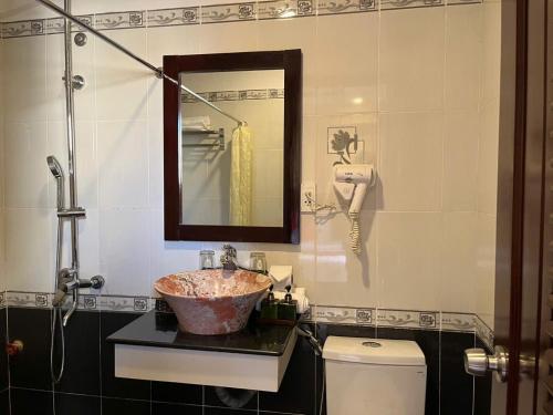 a bathroom with a sink and a toilet at Golden River Hotel in Hoi An