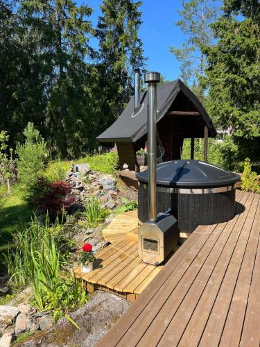 a wood deck with a stove on top of it at Cheerful house with sauna and bathtub in Almunge