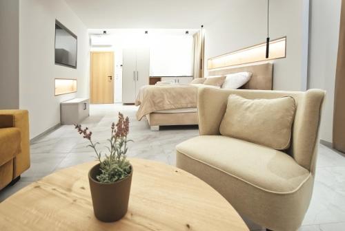 a living room with a couch and a table at Enotéka Vinofol - winebar & café & apartments in Mikulov