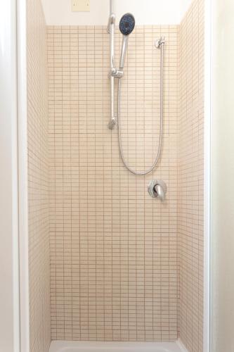 a bathroom with a shower with a tiled wall at Hotel Dell'Angelo in Rimini