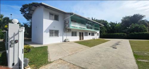 a large white house with a large driveway at Residence St Antoine in Cayenne