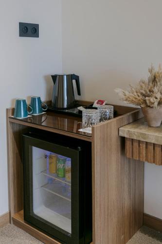a wooden table with a television in a room at NearYo Hotels in Marrakech