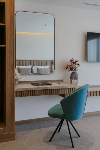 a desk with a chair and a mirror at NearYo Hotels in Marrakech