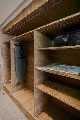 a closet with wooden shelves and a radio at NearYo Hotels in Marrakech