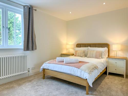 a bedroom with a large bed with two night stands at Modern Canterbury 3 Bedroom Townhouse - Pets Welcome & Free Parking in Canterbury