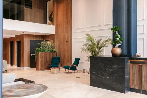 a lobby with green chairs and a table at NearYo Hotels in Marrakech