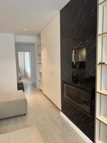a living room with a fireplace and a couch at Pipera Platza Residence 5 luxury 1 bedroom in Voluntari