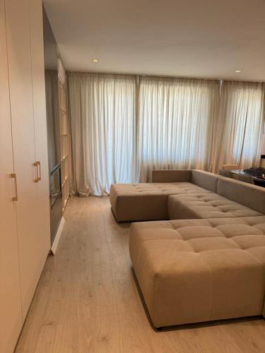 a large living room with two large beds in it at Pipera Platza Residence 5 luxury 1 bedroom in Voluntari