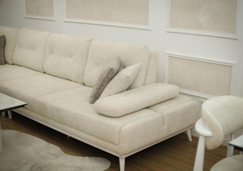 a white couch with pillows on it in a living room at Modern Apartment Peje in Peje