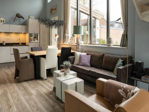 a living room with a couch and a table at Modern Forest Retreat in Bergen in Bergen