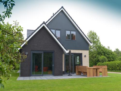 a house with a picnic table in the yard at Luxury Villa in Texel in Westermient
