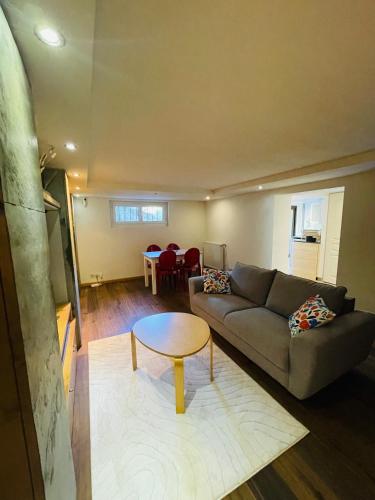 a living room with a couch and a table at Côté Nature in Sciez