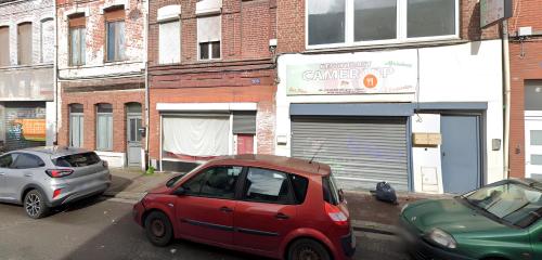 a red car is parked on a city street at Capstay - Roubaix - Grande Rue l Netflix - Wifi in Roubaix
