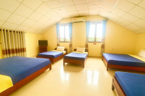 a hospital room with three beds and a tv at Golden River Hotel in Hoi An