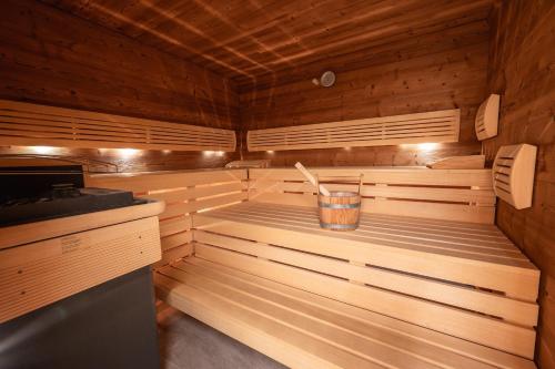 a sauna with a bucket in the middle of it at Hotel Gasthaus Schäfle in Bürserberg