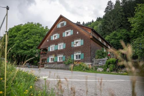 a large brick building on the side of a road at Hotel Gasthaus Schäfle in Bürserberg