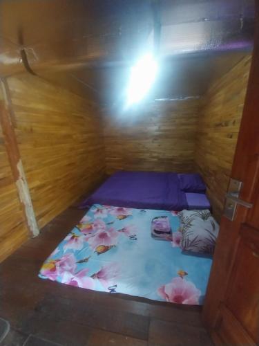 a small room with a bed in a wooden cabin at Varvara hill in Cigugur