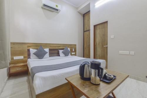 a bedroom with a bed and a table with a blender at Hotel Shivansh, RIICO Mansarovar in Jaipur