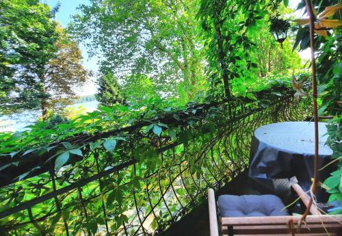 a table and a chair on a fence at Lake view for two, near Berlin in Zeuthen