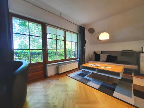 a living room with a couch and a coffee table at Lake view for two, near Berlin in Zeuthen