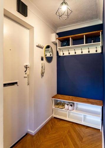 a room with a blue accent wall and a door at The Cove in Solihull